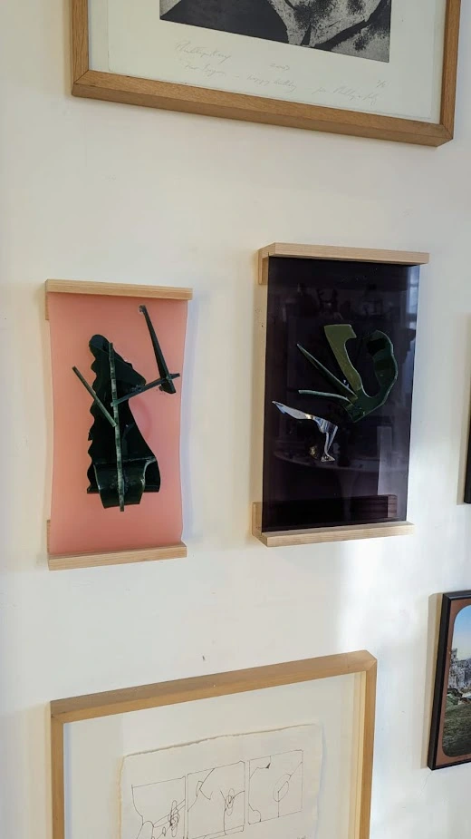 Two framed artworks on a wall